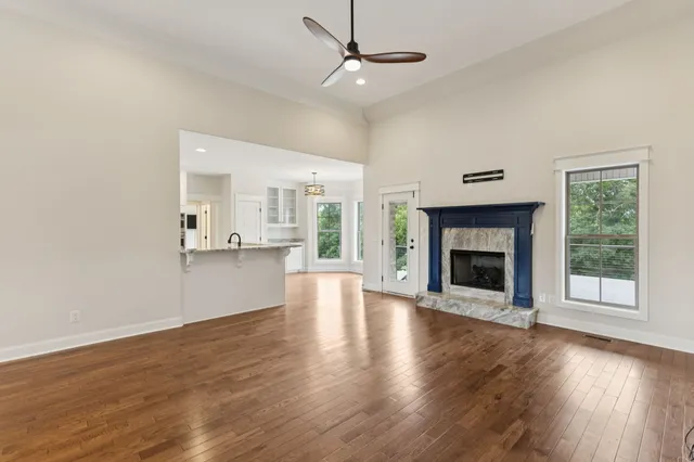 a living room with a fireplace and wooden floor