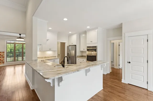 a kitchen with cabinets stainless steel appliances and a counter space