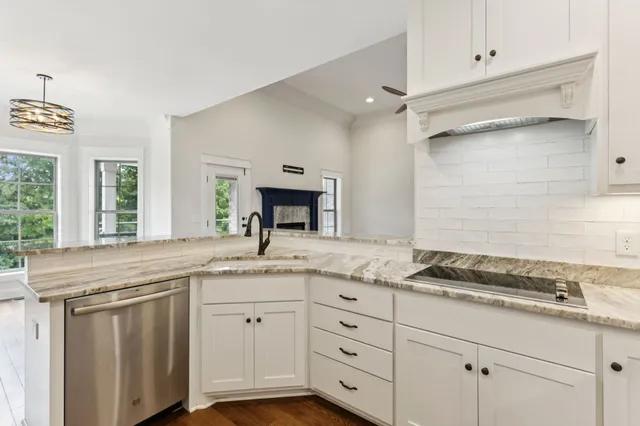 a view of a kitchen with wooden floor and windows