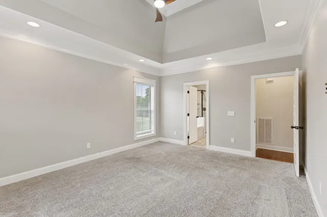 an empty room with a chandelier fan