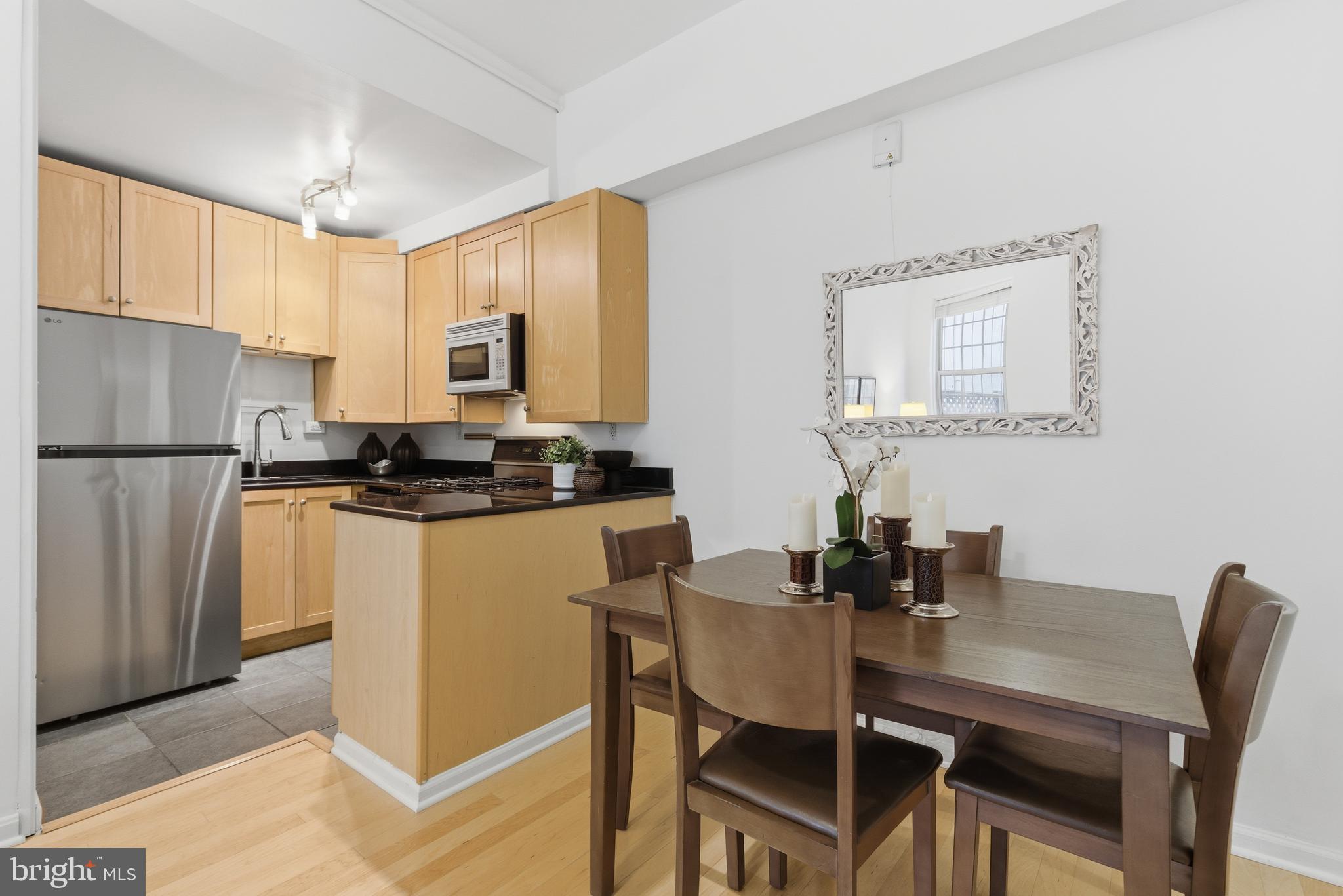 101 North Carolina Avenue Southeast, Unit G Washington, DC 20003 - Photo 4 of 17 a kitchen with a dining table chairs and refrigerator