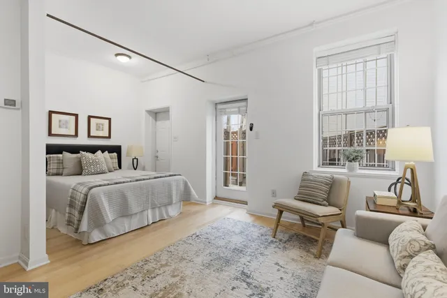 a spacious bedroom with a bed and couch