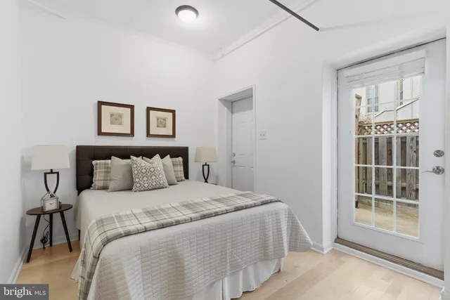 a large bed sitting in a bedroom next to a window