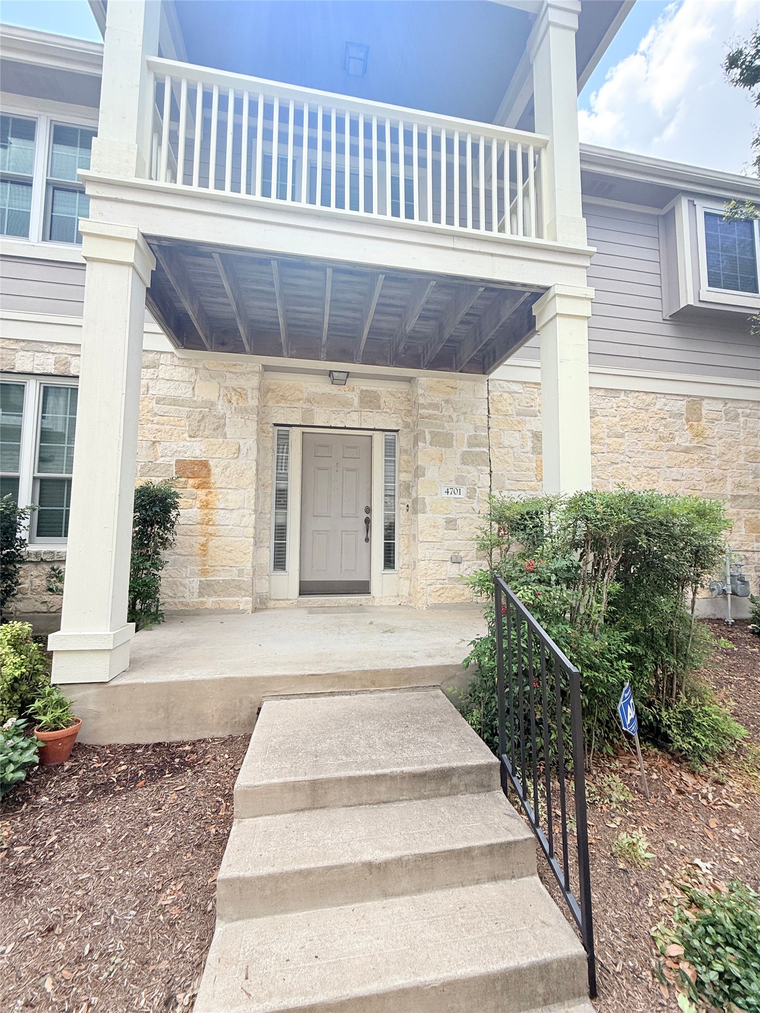 1900 Scofield Ridge Parkway, Unit 4701 Austin, TX 78727 - Photo 27 of 27 Stone facade and balcony welcome guests to this inviting townhome entry.