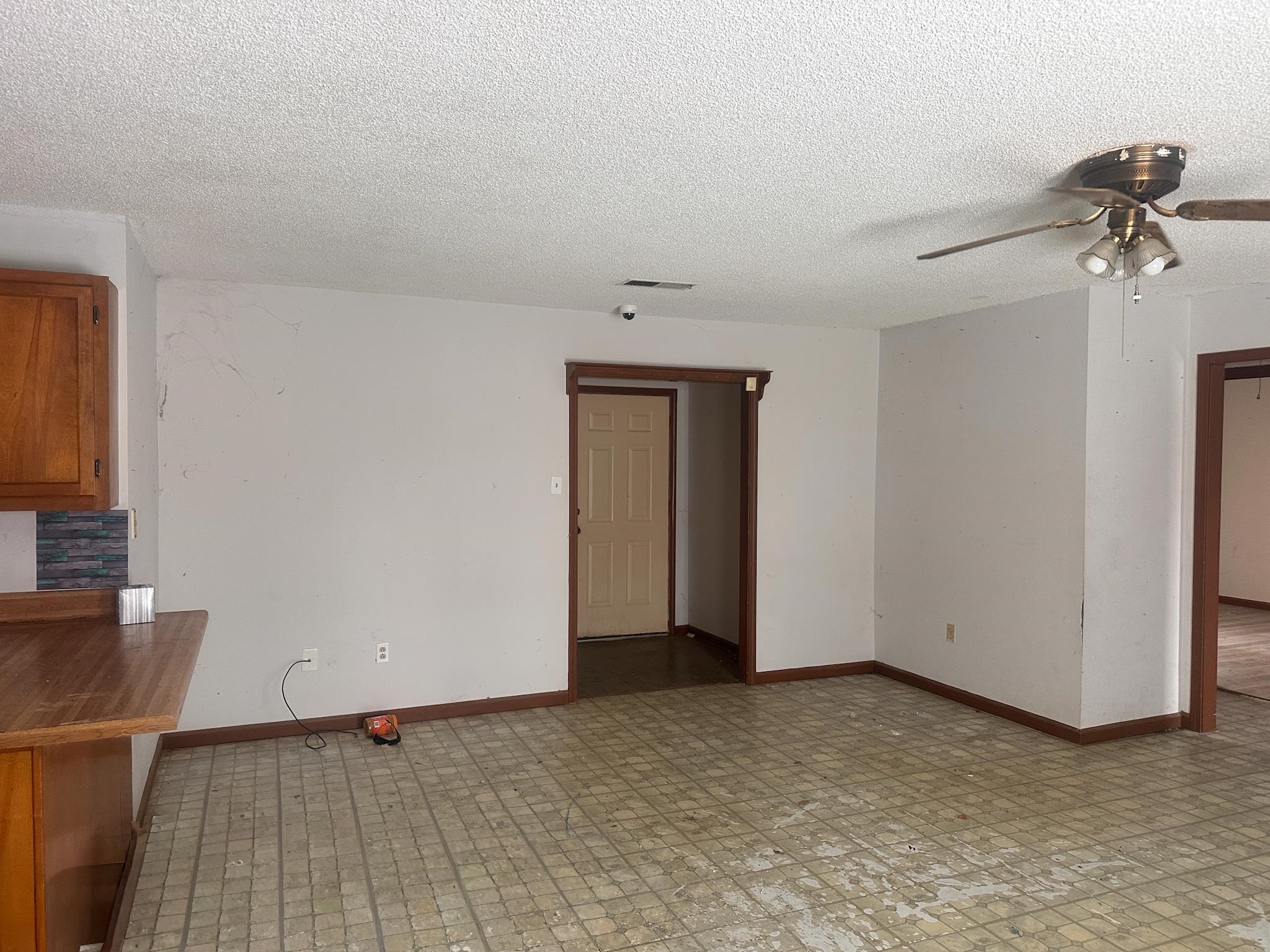 605 Jr Drive Covington, TN 38019 - Photo 6 of 21 Unfurnished room featuring a ceiling fan, light floors, and a textured ceiling