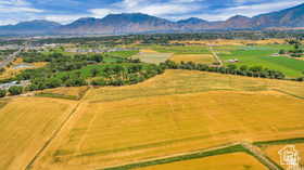 19 East Southfield Road Spanish Fork, UT 84660 - Photo 9 of 74 Aerial view of sparsely populated area featuring a mountain backdrop and extensive farmland