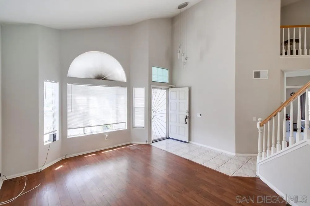 9185 Lake Valley Road El Cajon, CA 92021 - Photo 8 of 43 an empty room with wooden floor and windows