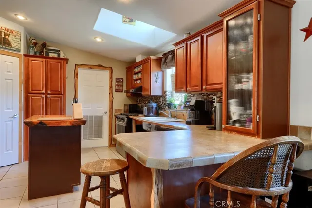 a dining room with furniture and a floor to ceiling window