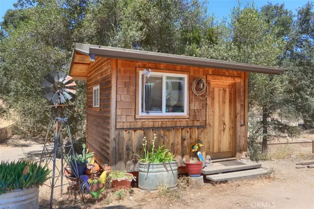 a backyard of a house with barbeque oven and a bench