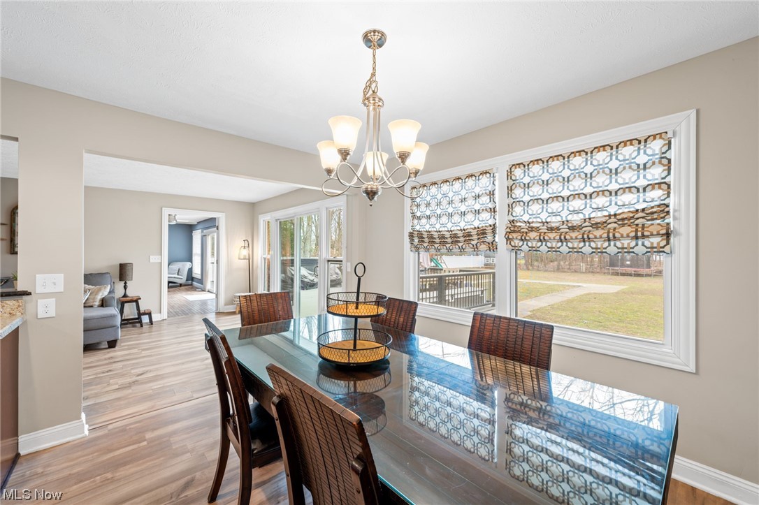 2425 McMackin Road Madison, OH 44057 - Photo 12 of 46 Dining room with a chandelier and light hardwood / wood-style flooring