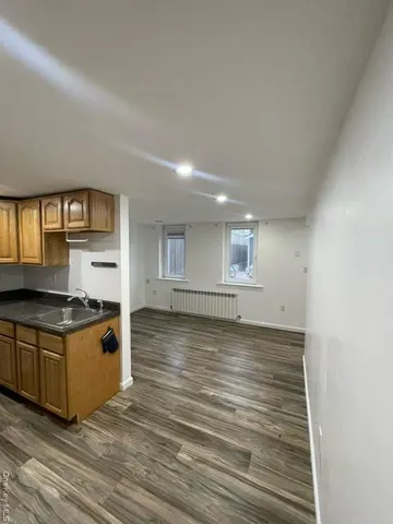 a view of a kitchen with a stove cabinets and wooden floor