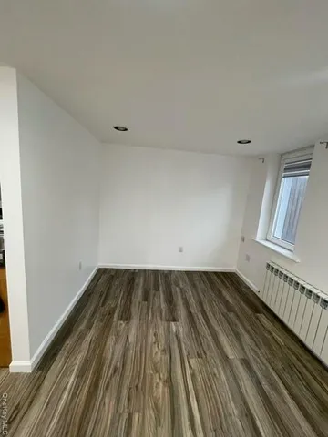 a view of a room with wooden floor