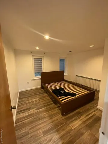 a living room with hard wood floors and a rug