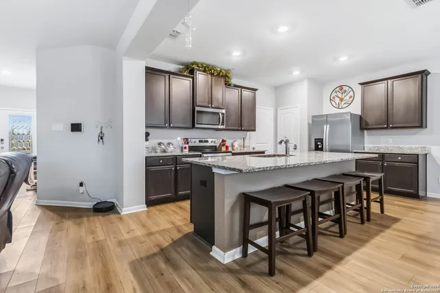 a kitchen with stainless steel appliances granite countertop a sink and stove