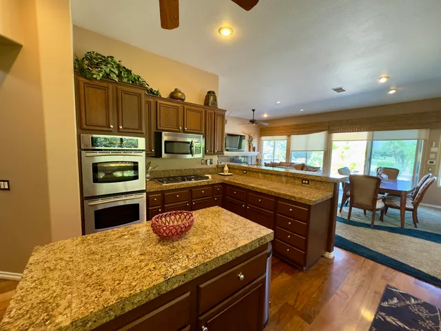 a kitchen with a stove a sink and a refrigerator