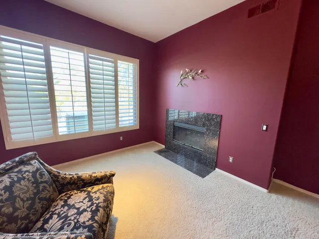 a bedroom with a bed and a fireplace