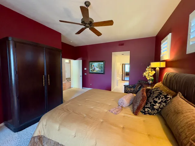 a bed room with a bed and a chandelier