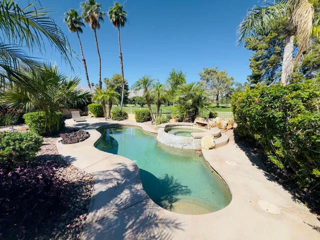 a view of a swimming pool with a yard