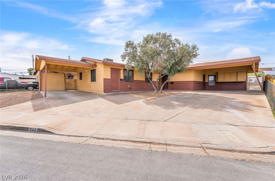 242 Nebraska Avenue Henderson, NV 89015 - Photo 1 of 46 Single story Duplex each with an attached carport, concrete driveway, and stucco siding