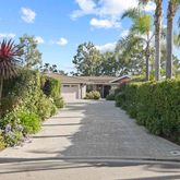a view of a house with a yard and pathway