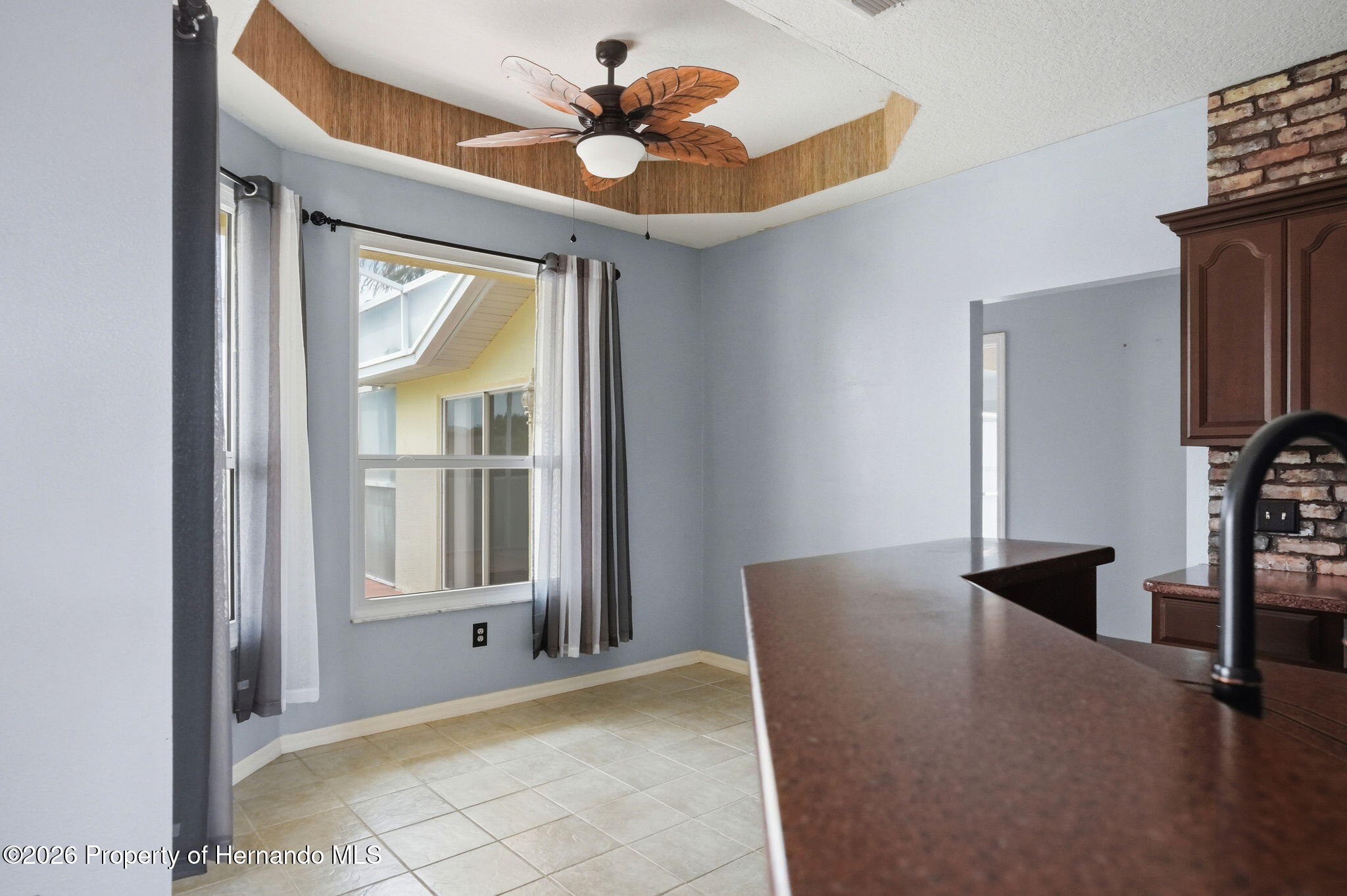18131 Rivard Boulevard Brooksville, FL 34604 - Photo 21 of 66 a view of an empty room with a window and a kitchen