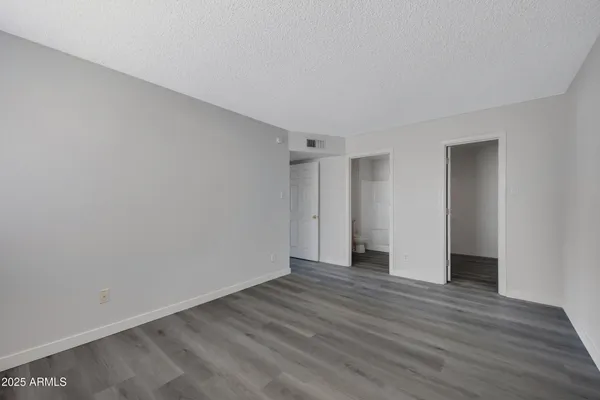 a view of an empty room with wooden floor