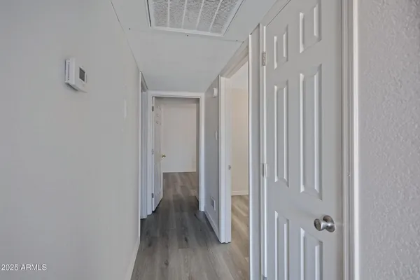 a view of a hallway with wooden floor