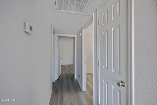 a view of a hallway with wooden floor