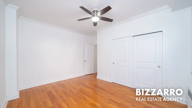 a view of a hallway to a bedroom with wooden floor