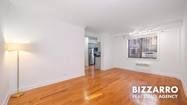 a bedroom with a balcony a bed and a window