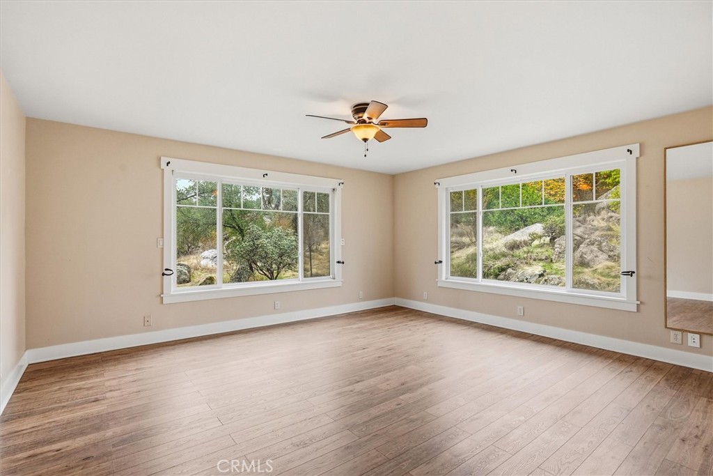 4489 Varain Road Mariposa, CA 95338 - Photo 12 of 39 an empty room with windows and a ceiling fan