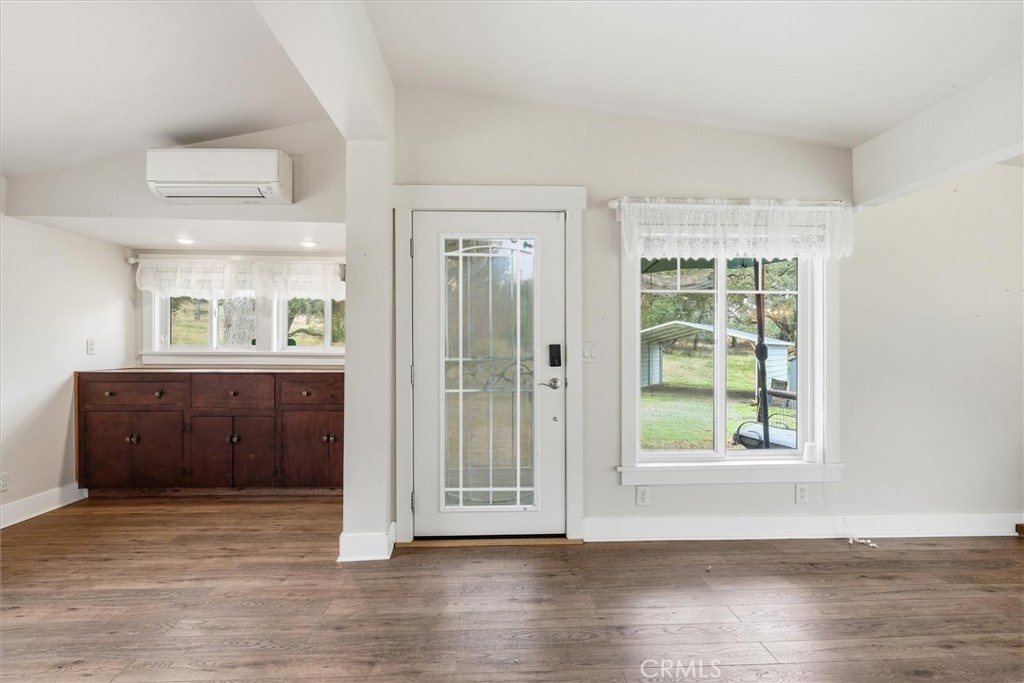 4489 Varain Road Mariposa, CA 95338 - Photo 14 of 39 an empty room with wooden floor and windows