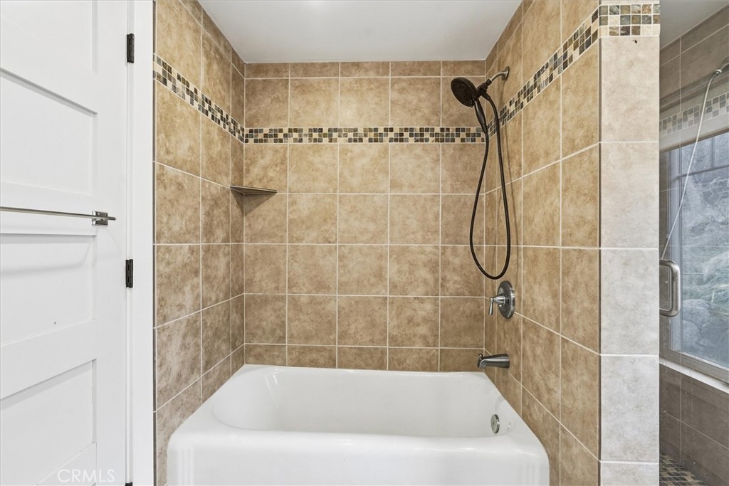 4489 Varain Road Mariposa, CA 95338 - Photo 16 of 39 a bathroom with a bath tub with a shower