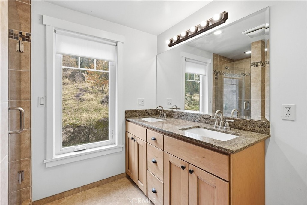 4489 Varain Road Mariposa, CA 95338 - Photo 17 of 39 a bathroom with a granite countertop sink and a mirror