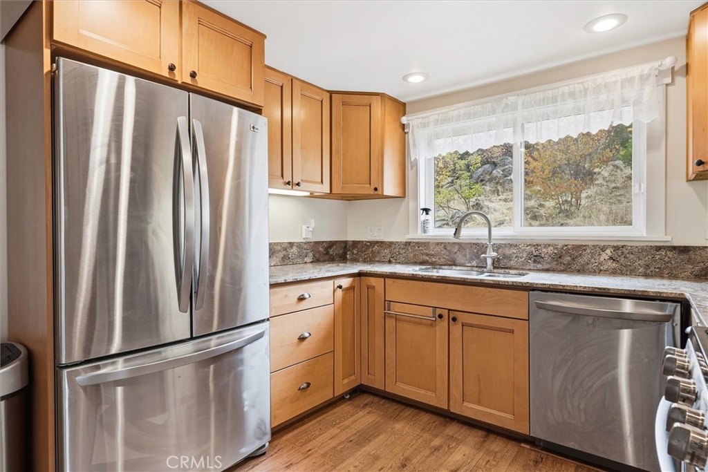 4489 Varain Road Mariposa, CA 95338 - Photo 19 of 39 a kitchen with stainless steel appliances granite countertop a refrigerator sink and cabinets