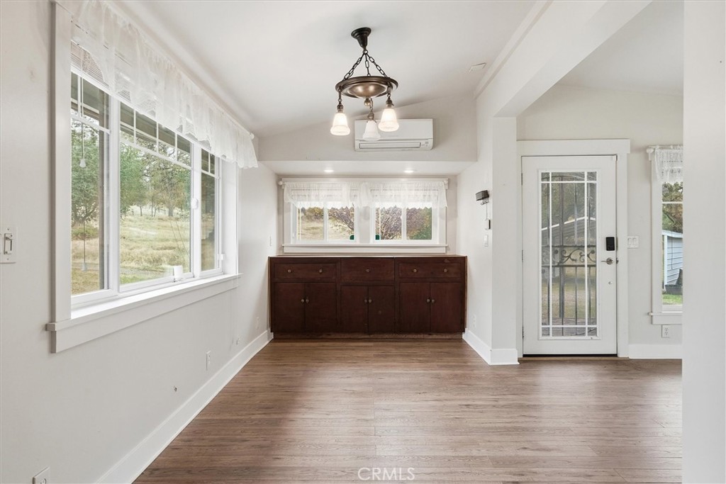 4489 Varain Road Mariposa, CA 95338 - Photo 23 of 39 a living room with a large window and wooden floor