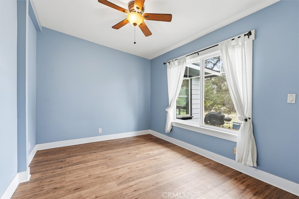 4489 Varain Road Mariposa, CA 95338 - Photo 6 of 39 a view of an empty room with a window and wooden floor