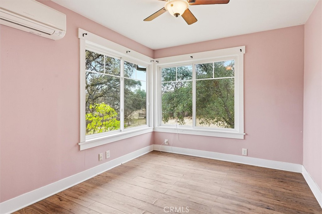 4489 Varain Road Mariposa, CA 95338 - Photo 8 of 39 an empty room with wooden floor and windows
