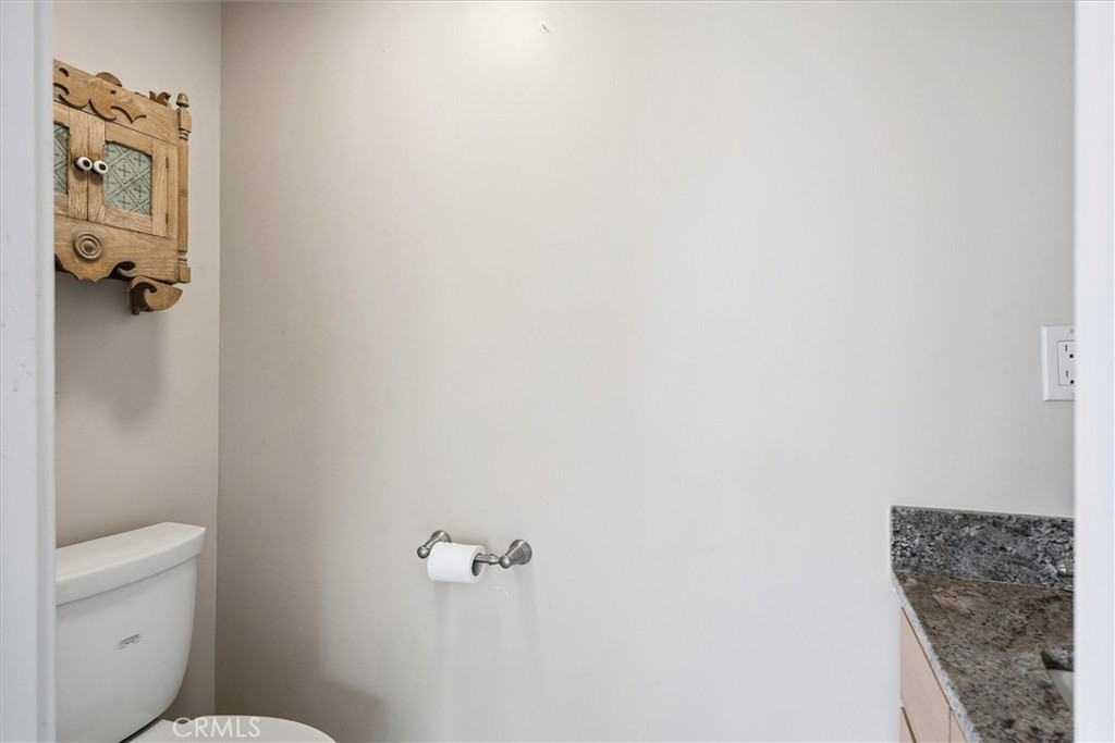 4489 Varain Road Mariposa, CA 95338 - Photo 9 of 39 a bathroom with a granite countertop toilet and a shower