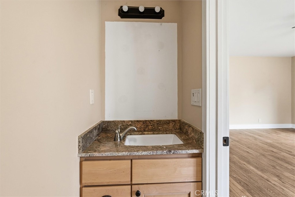 4489 Varain Road Mariposa, CA 95338 - Photo 10 of 39 a bathroom with a granite countertop sink and a mirror