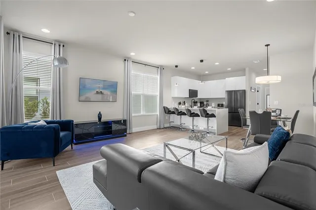 a living room with furniture and kitchen view