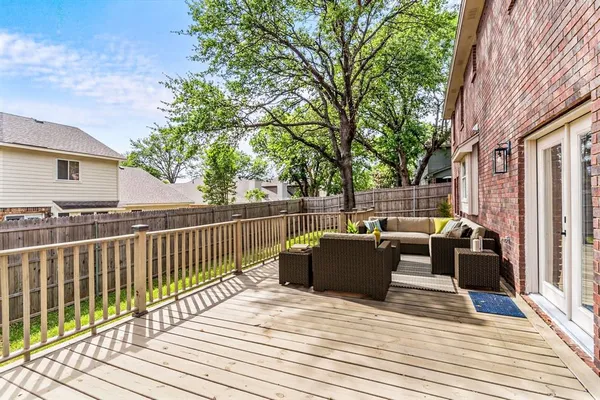 a view of a deck with couches and wooden floor