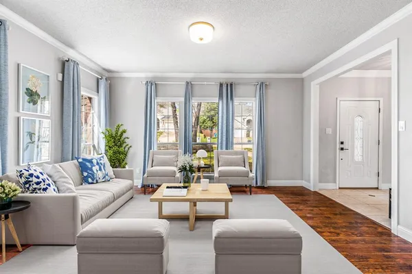 a living room with furniture and floor to ceiling windows