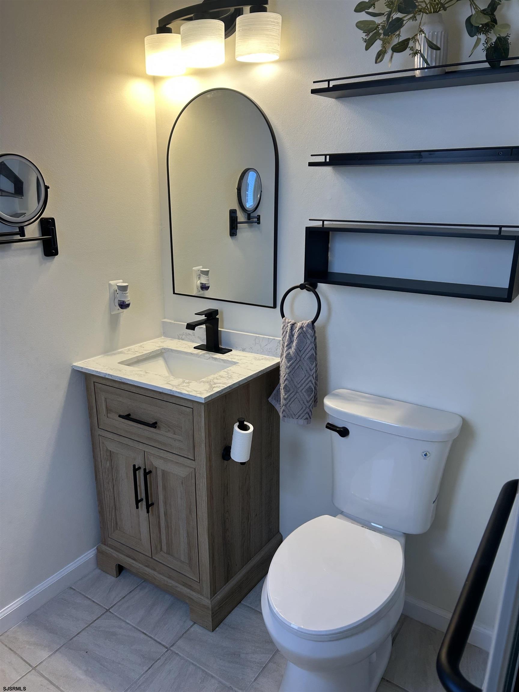 12 Vardon Road Brigantine, NJ 08203 - Photo 15 of 28 a bathroom with a toilet sink and mirror