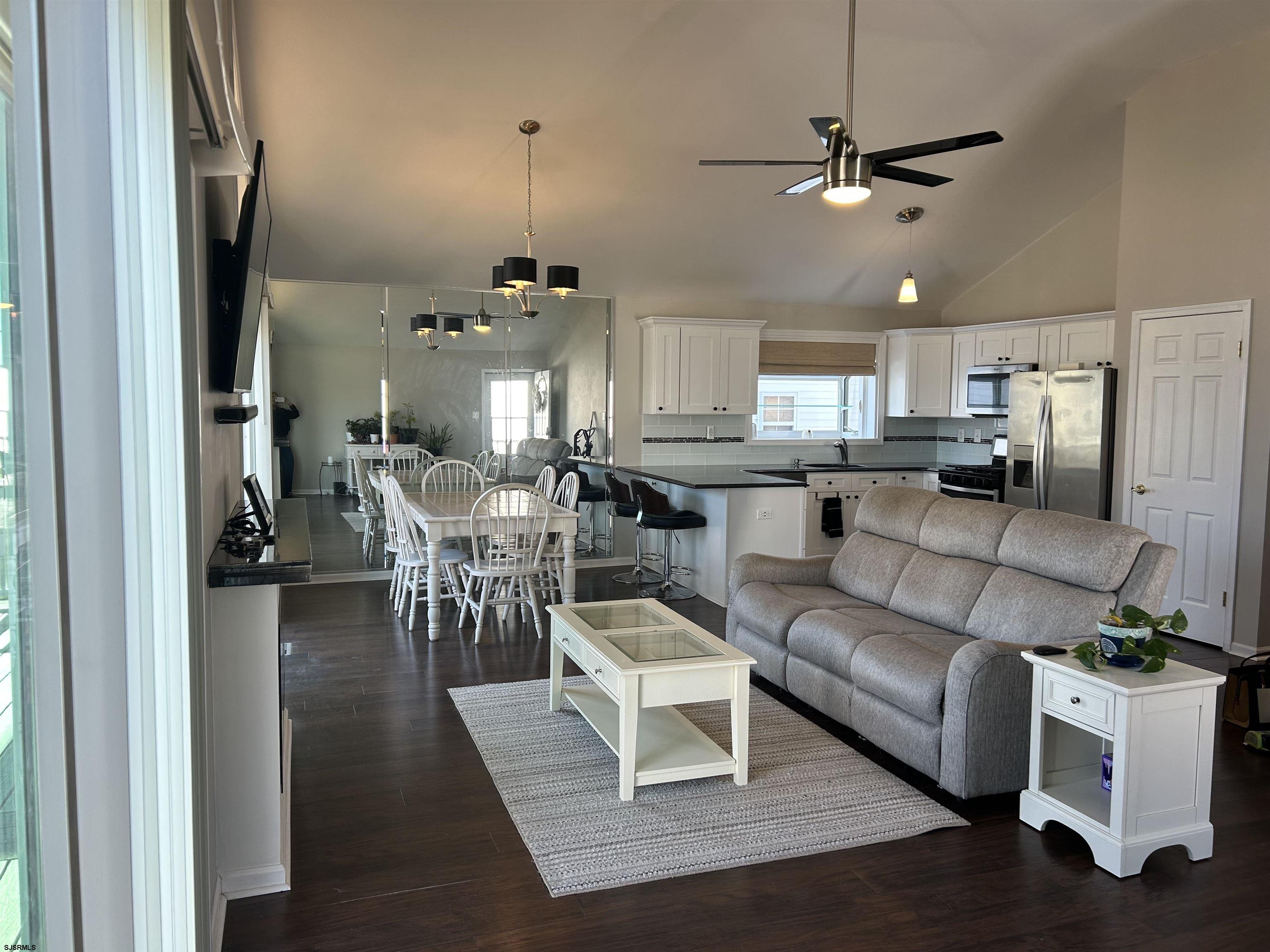12 Vardon Road Brigantine, NJ 08203 - Photo 4 of 28 a living room with furniture kitchen view and a chandelier