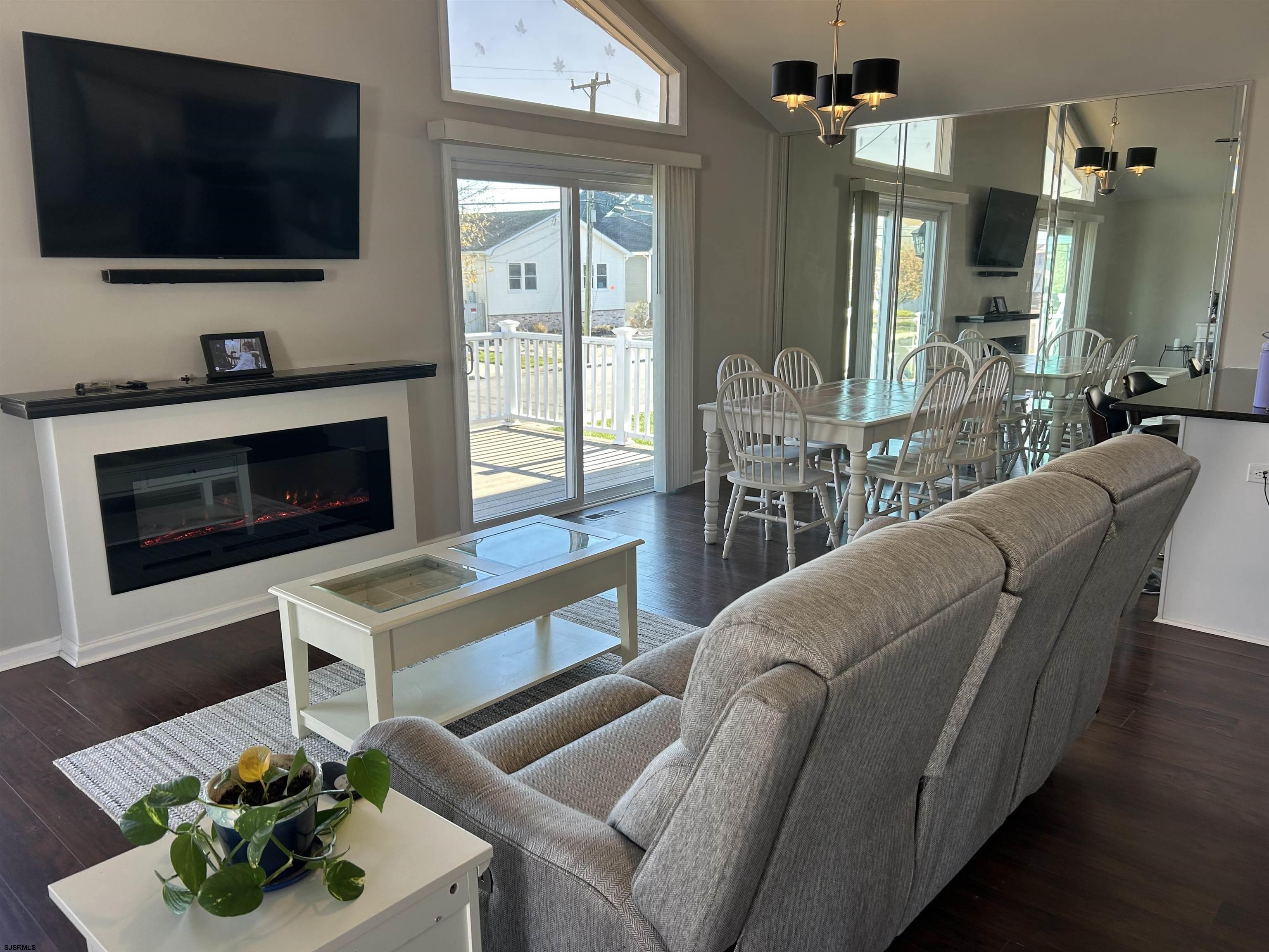 12 Vardon Road Brigantine, NJ 08203 - Photo 5 of 28 a living room with furniture a flat screen tv and a fireplace