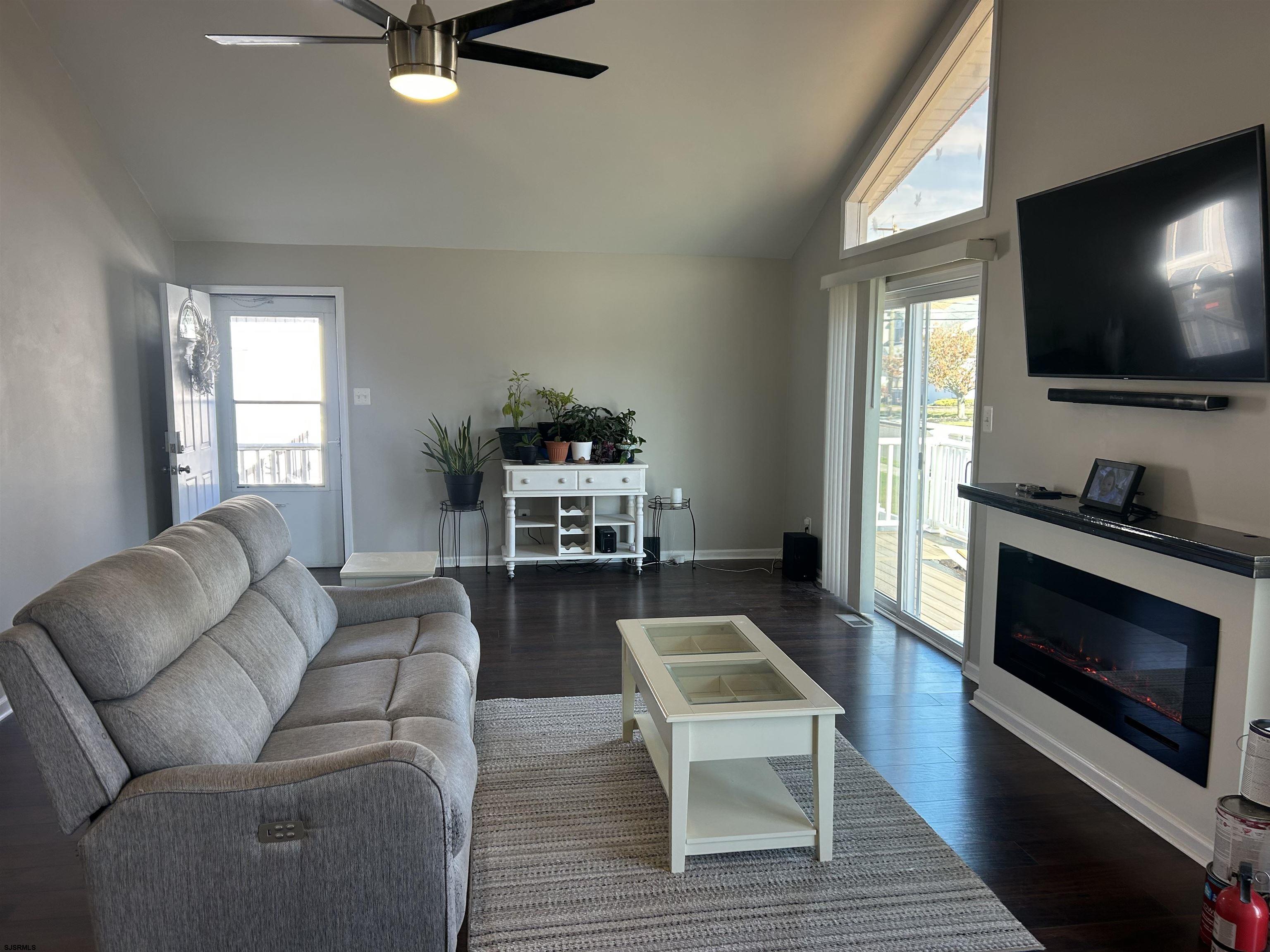 12 Vardon Road Brigantine, NJ 08203 - Photo 8 of 28 a living room with furniture a flat screen tv and a fireplace