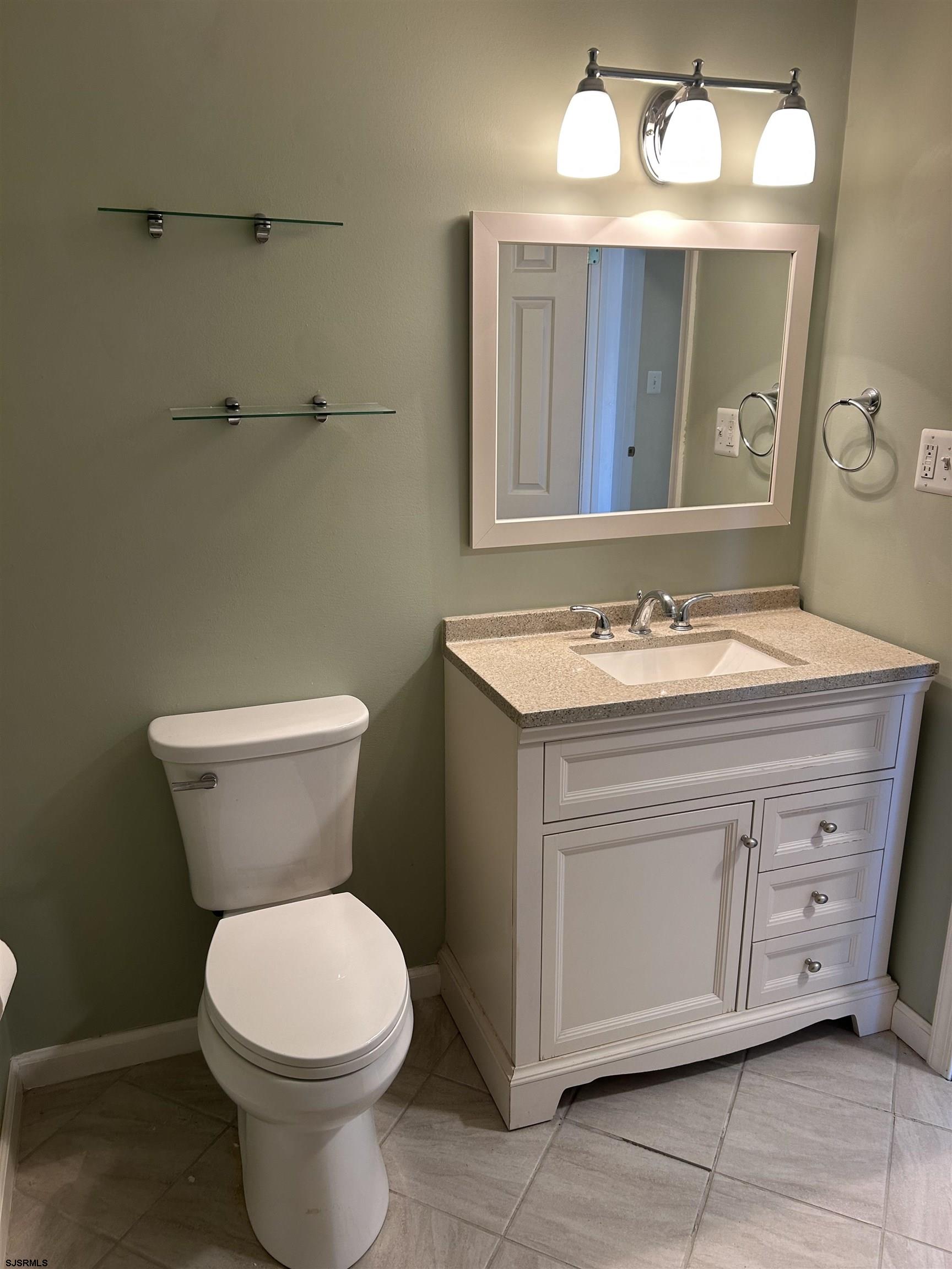12 Vardon Road Brigantine, NJ 08203 - Photo 9 of 28 a bathroom with a toilet sink and mirror