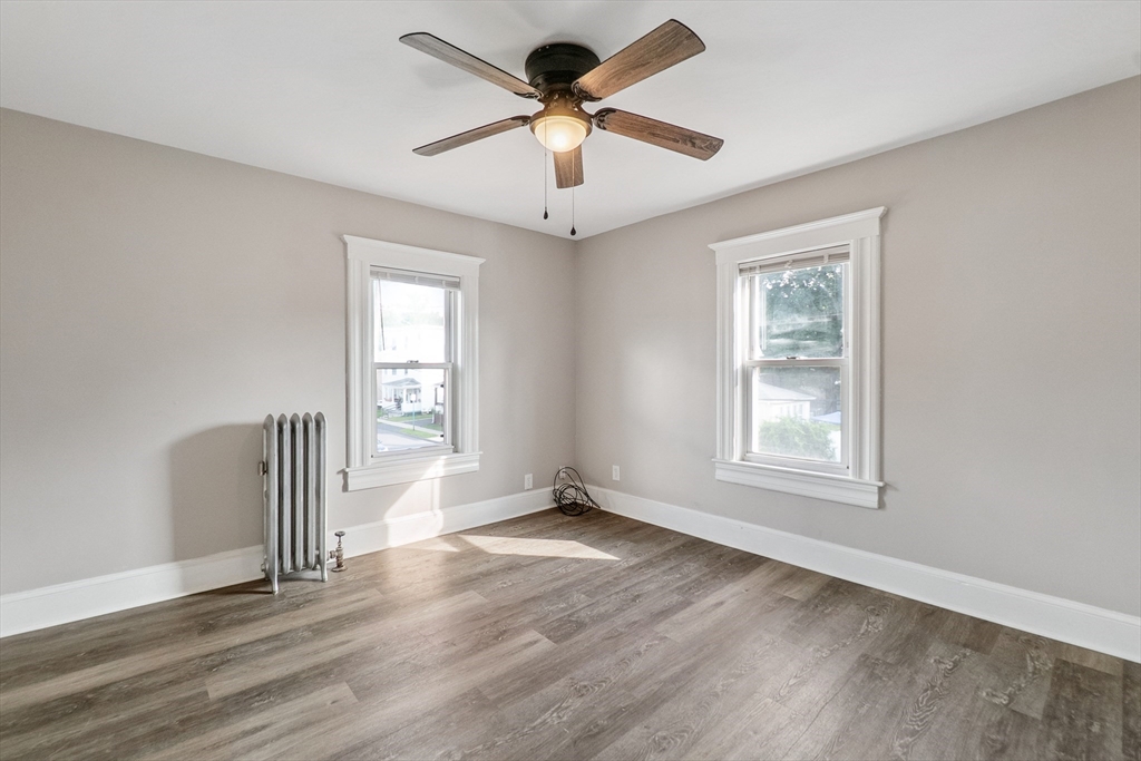 26 Olivine Street Chicopee, MA 01013 - Photo 15 of 26 a view of an empty room with a window and wooden floor