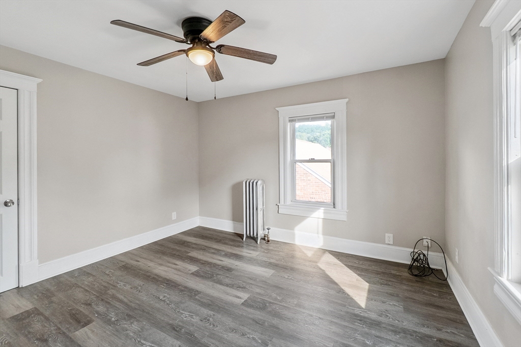 26 Olivine Street Chicopee, MA 01013 - Photo 17 of 26 wooden floor in an empty room with a window